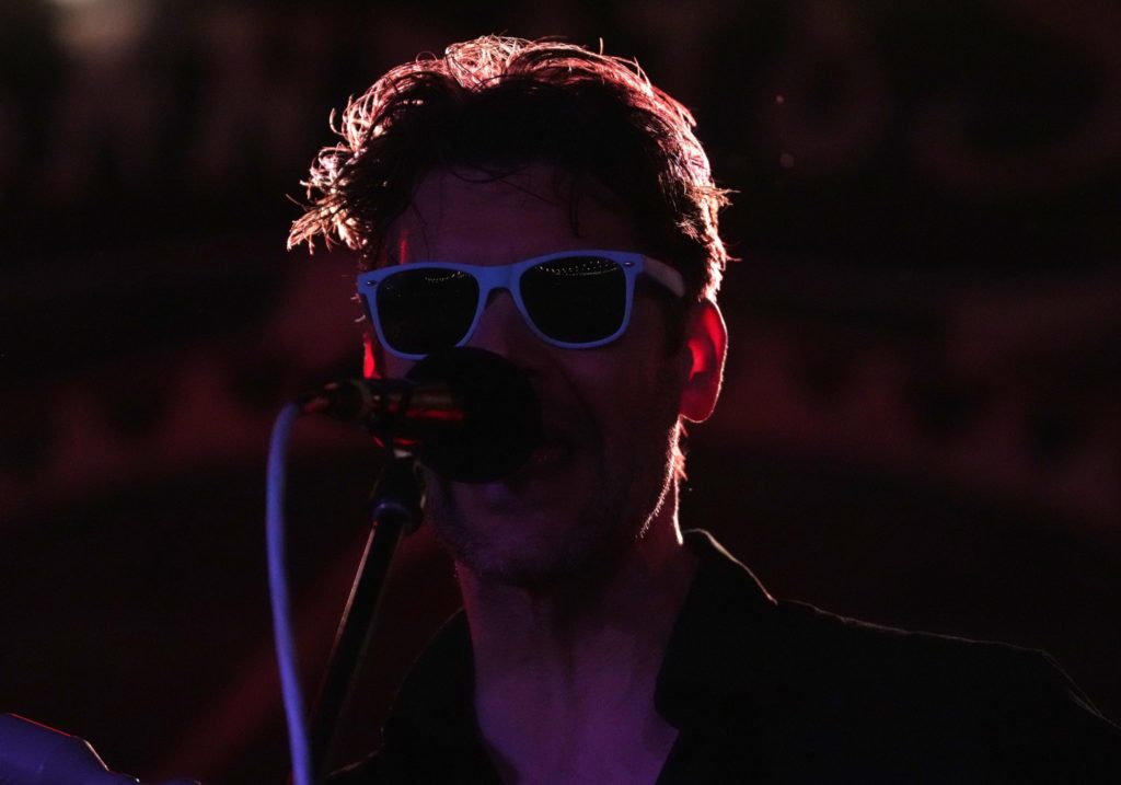 Closeup of singer in dark shadows